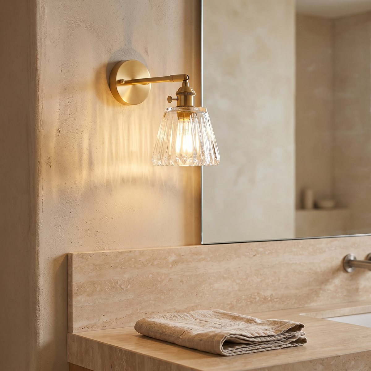 Brass Ribbed Glass Wall Sconce beside a mirror